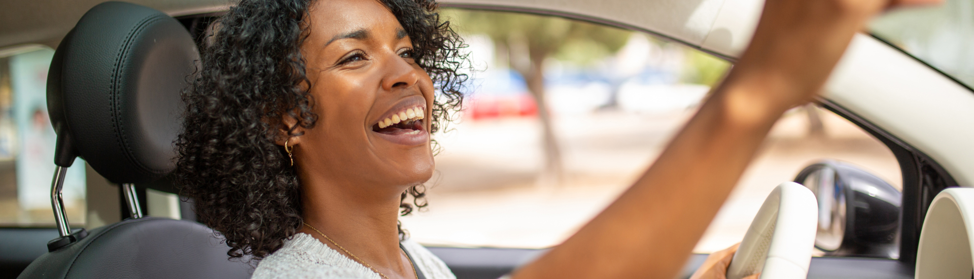 Lady looking at rear mirror in her new car
