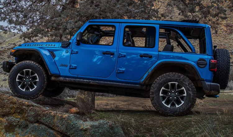 Blue Jeep Wrangler driving off-road