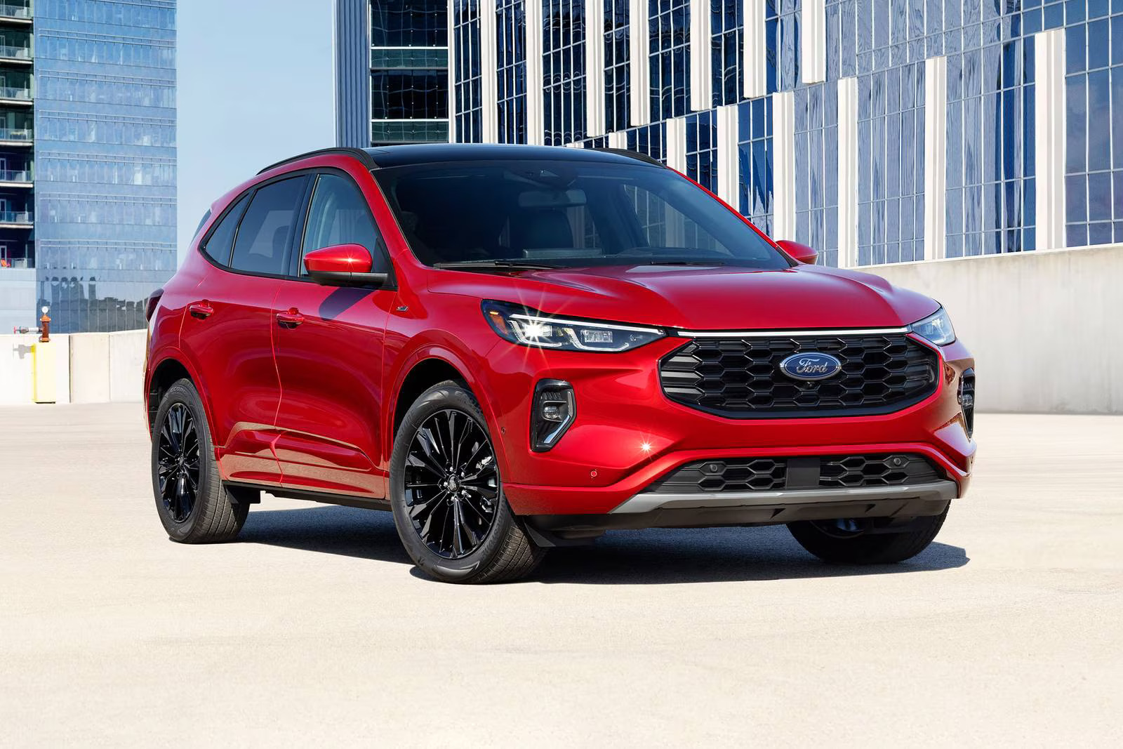 A red ford escape sitting parked in front of a biulding.